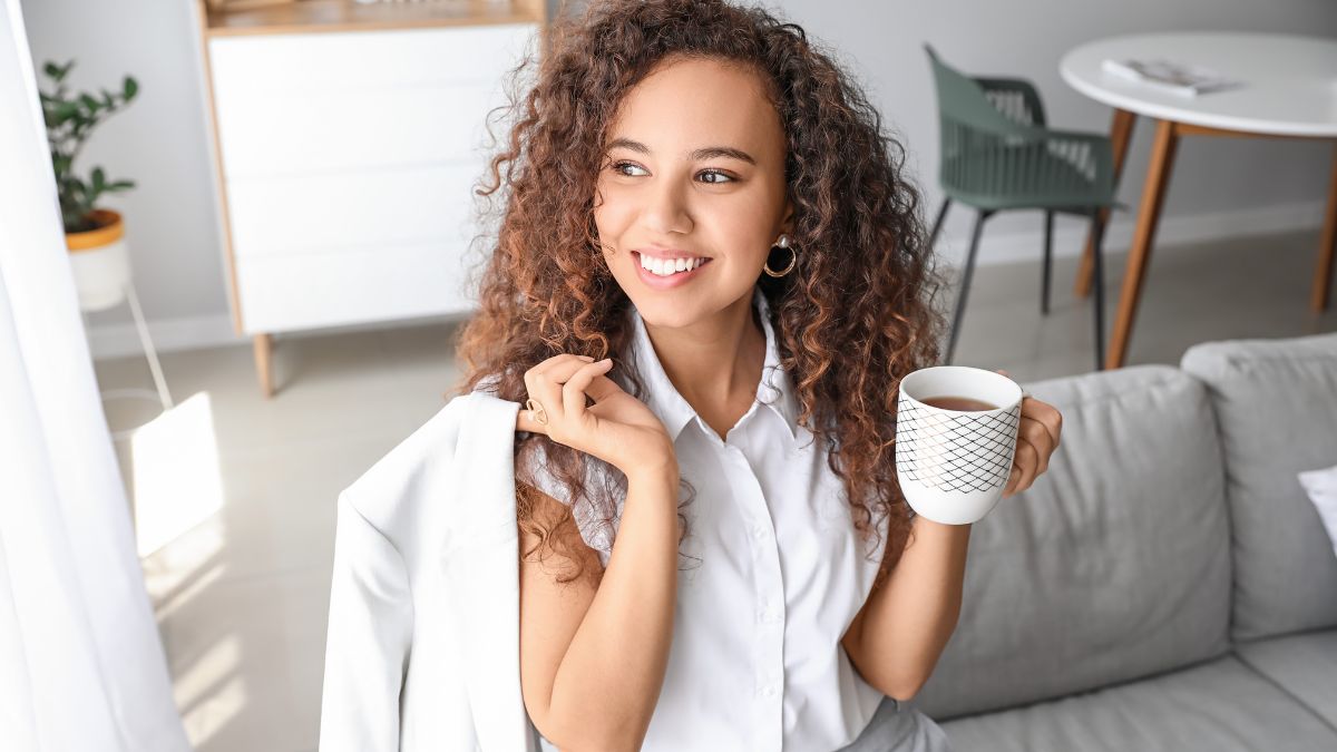 Woman dressed in a business suit drinking a cup of coffee