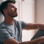 Man sitting on the floor looking to be depressed