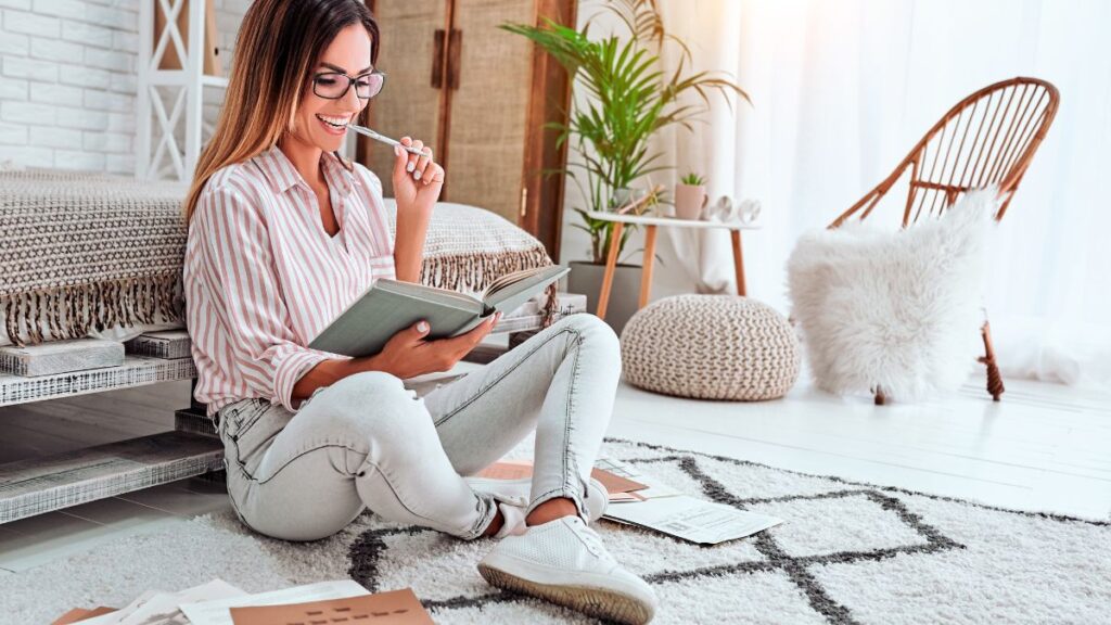 Woman sitting on the floor making a to-do list