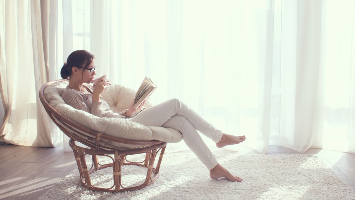 Woman sitting in a chair resting and reading a book