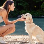 Woman playing with her dog on the beach