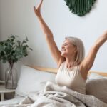 Woman waking up feeling energized and refreshed in the morning