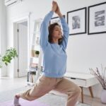 Woman doing yoga in her living room