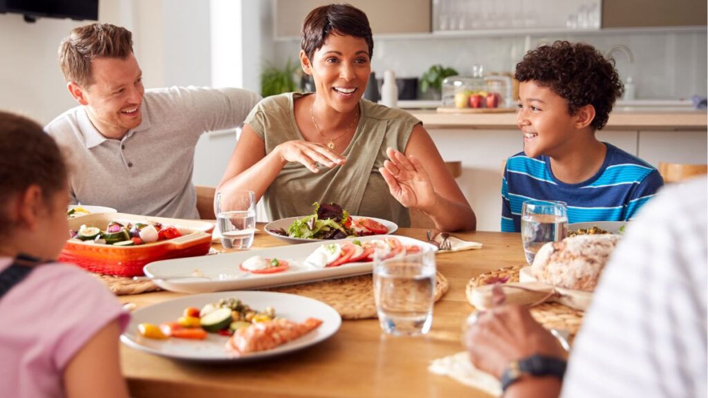 Family sitting around the table eating together