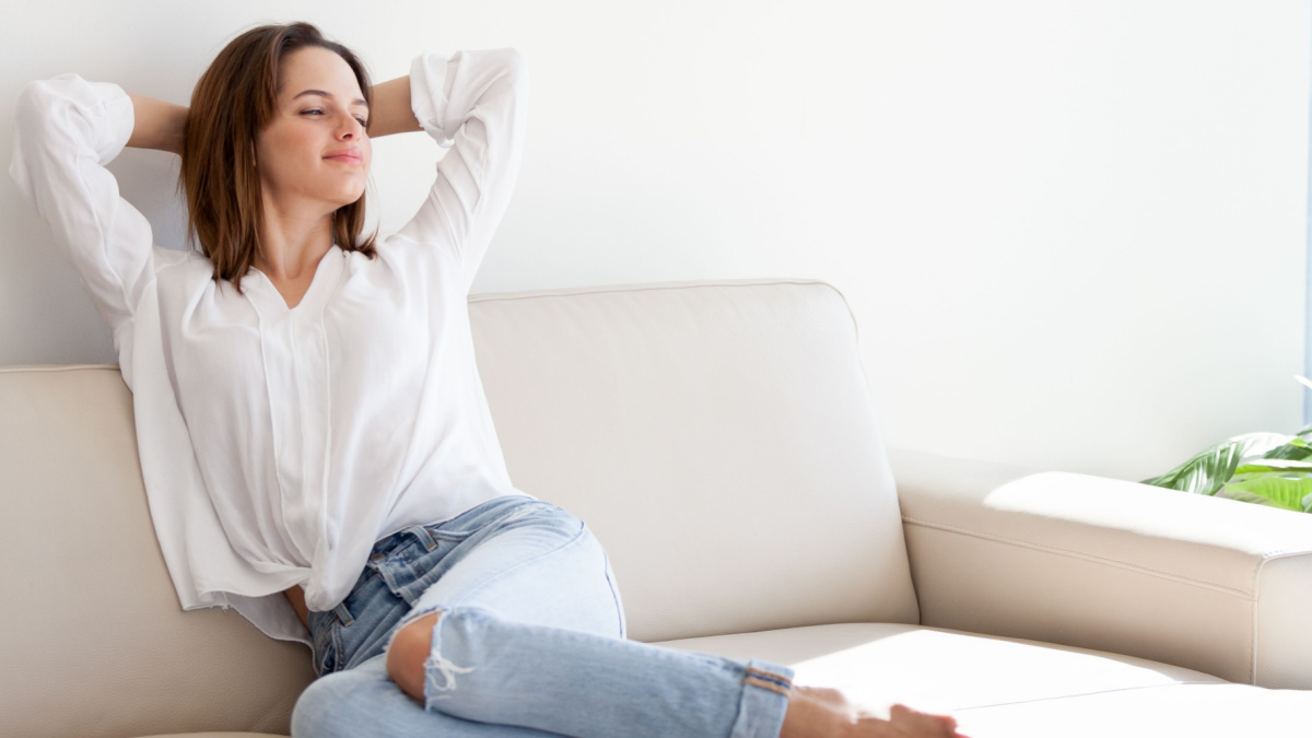 Young happy woman relaxing on the couch