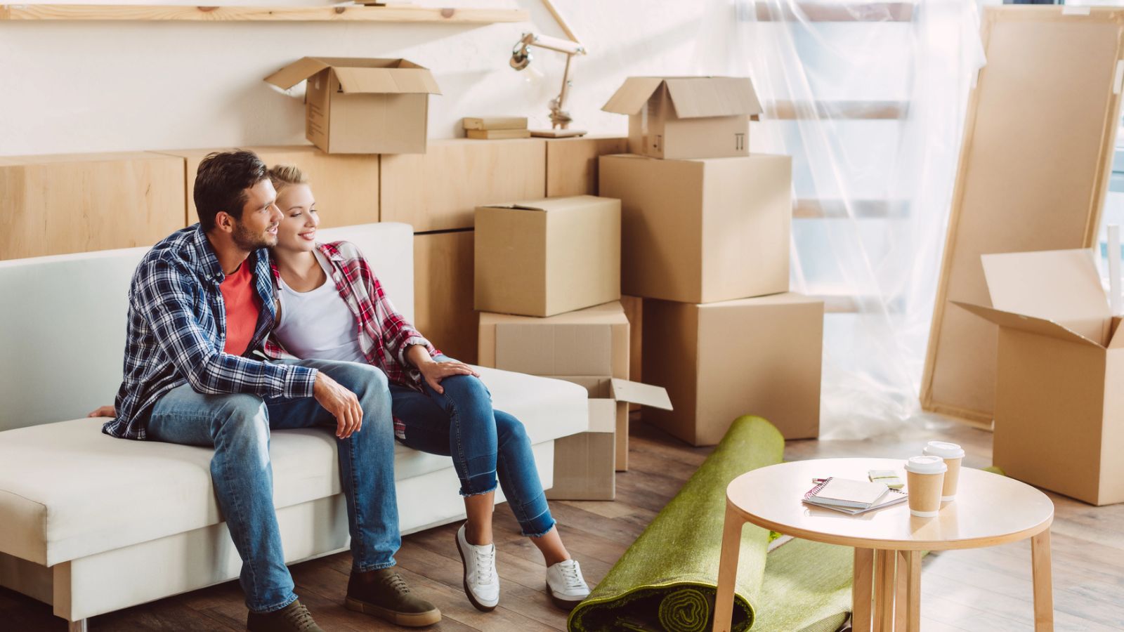 Couple sitting on couch when moving into a new home