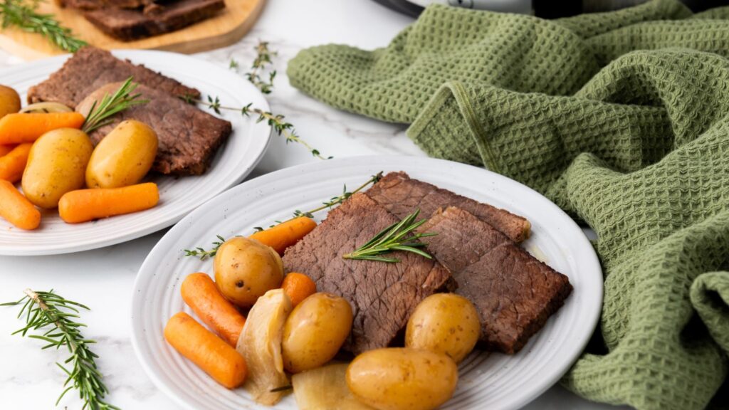 Two plates with rump roast and vegetables