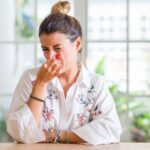 Woman pinching her nose for a bad smell