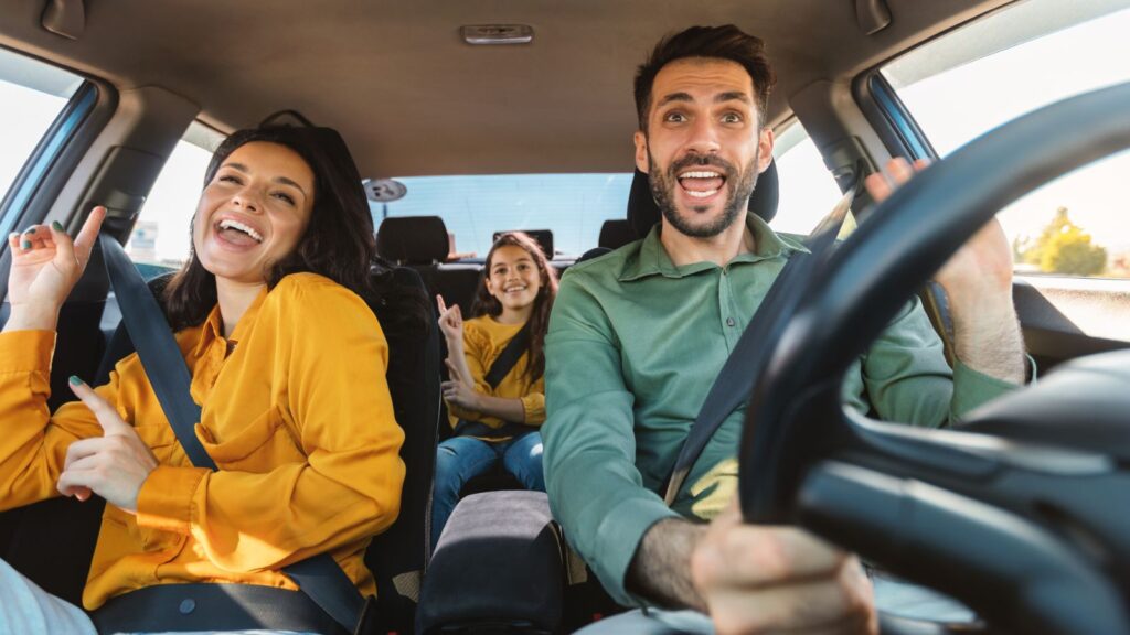 Family driving and laughing in the car