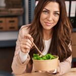 Woman eating a salad in her office