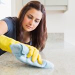 Woman cleaning counter with a cloth