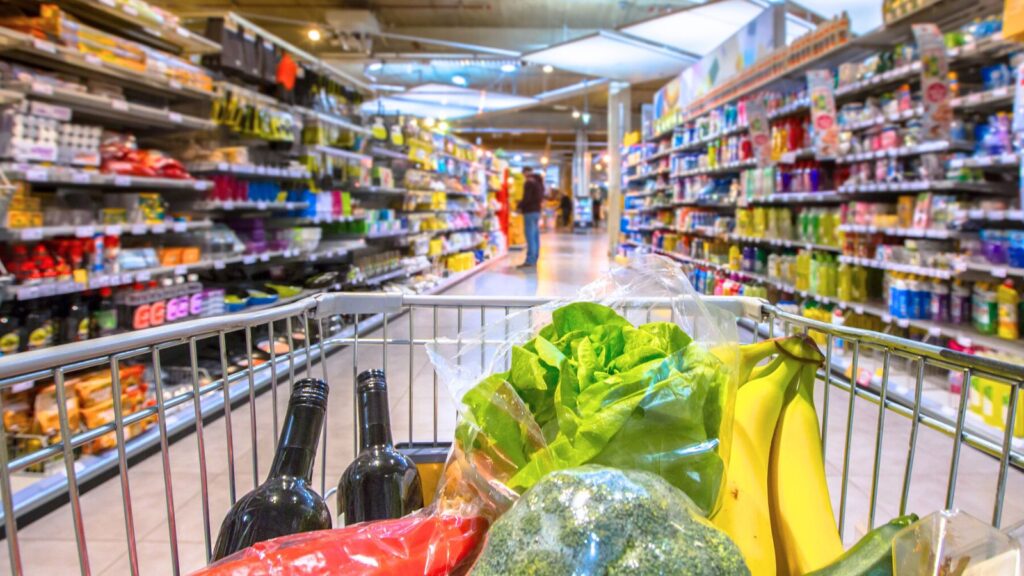 Shopping cart with healthy food and vegetables in it