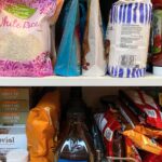 Messy, crowded kitchen cabinet