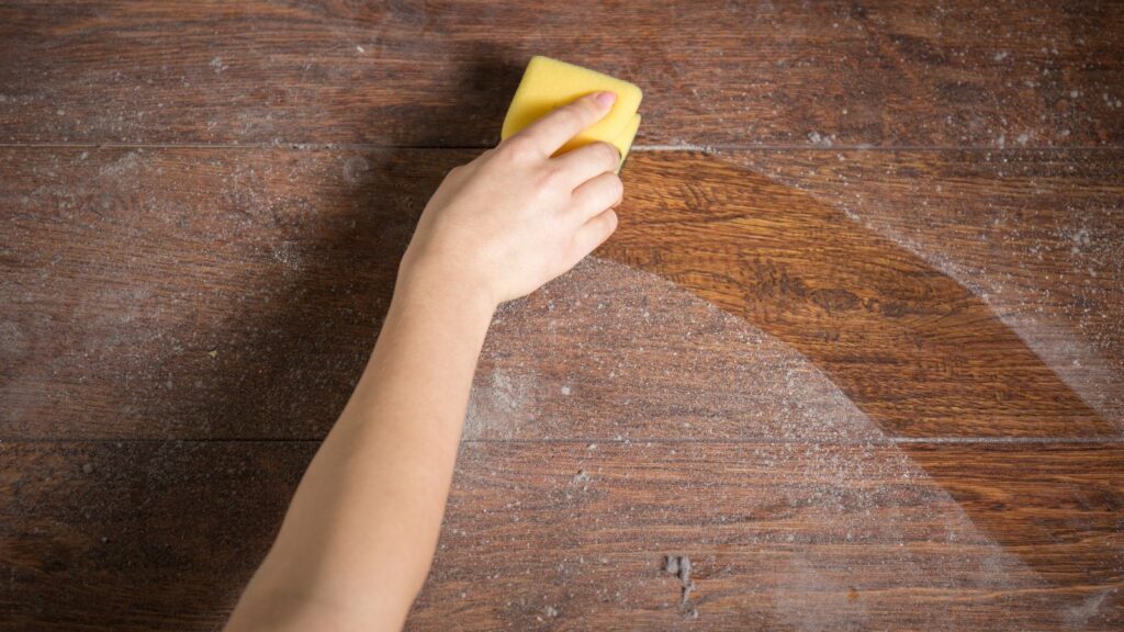 Person dusting a dusty surface