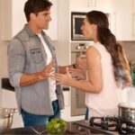 Couple arguing in kitchen while cooking