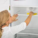 Woman cleaning a refrigerator