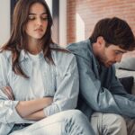 Couple sitting on the couch arguing