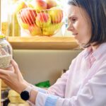 Woman looking at items in her pantry