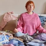 Woman meditating on a messy bed