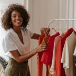 Woman looking through clothes hanging on a rack