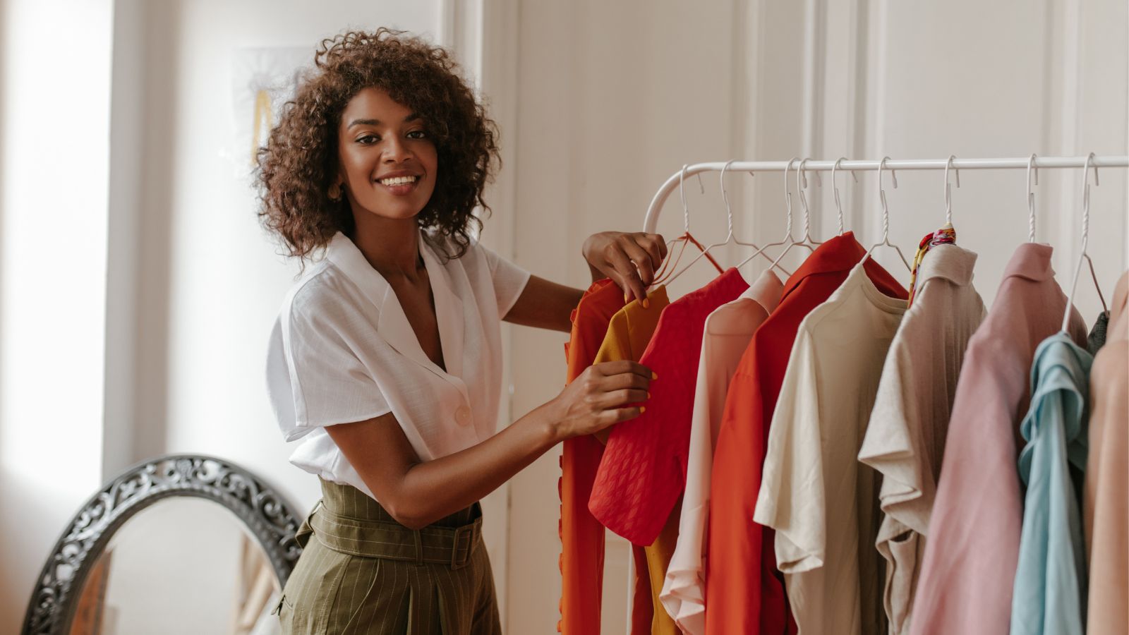 Woman looking through clothes hanging on a rack