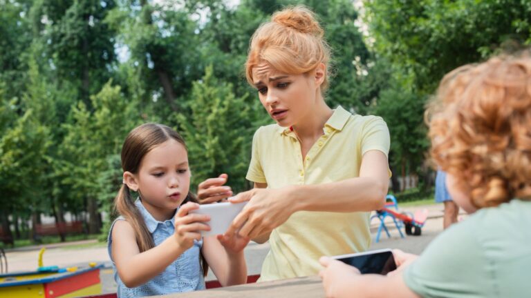 Mom looking worried with kids at a playground
