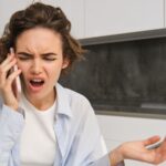 Young woman on a phone call looking angry