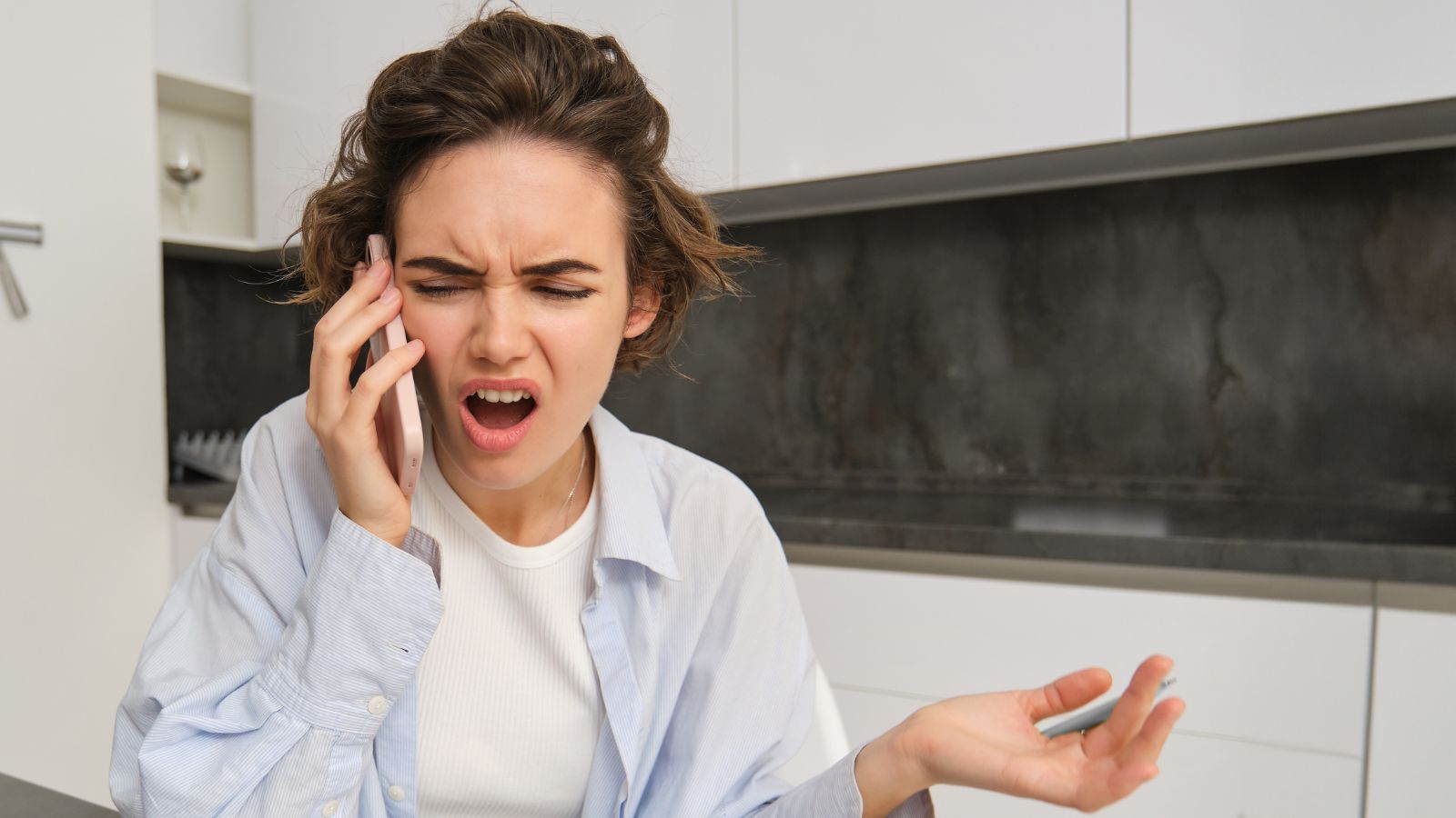 Young woman on a phone call looking angry
