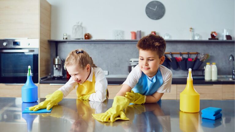 Kids wearing gloves and wiping the counter