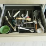 Messy open drawer in a kitchen