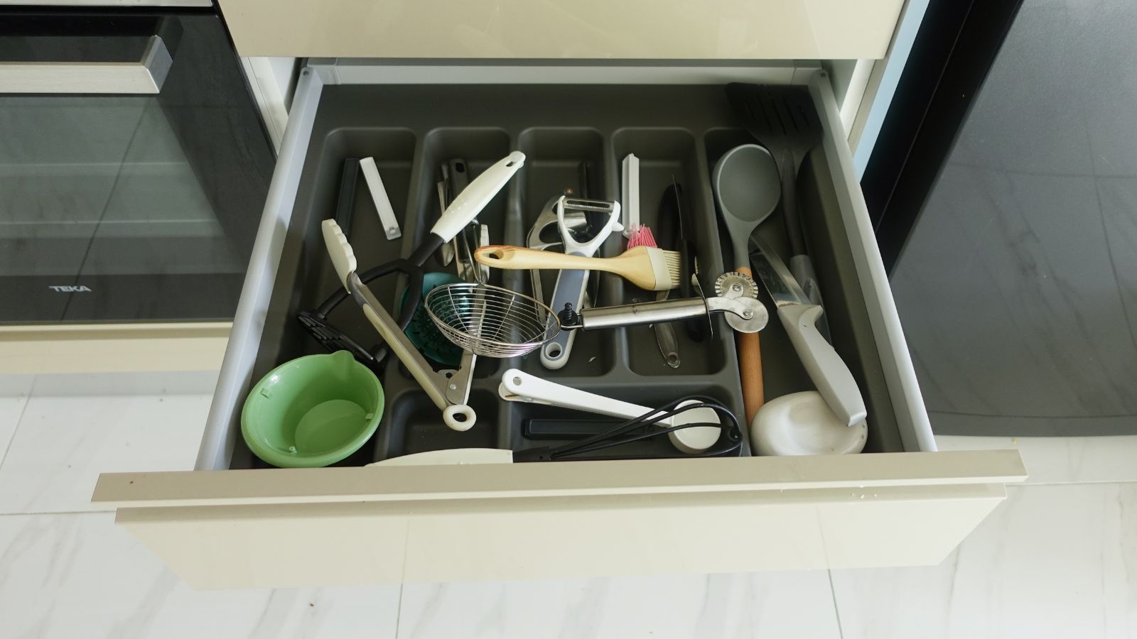 Messy open drawer in a kitchen