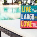 Wall decor on a chair next to a pool