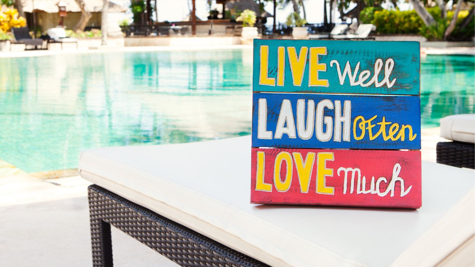 Wall decor on a chair next to a pool