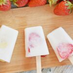 Homemade fruit popsicles on a cutting board