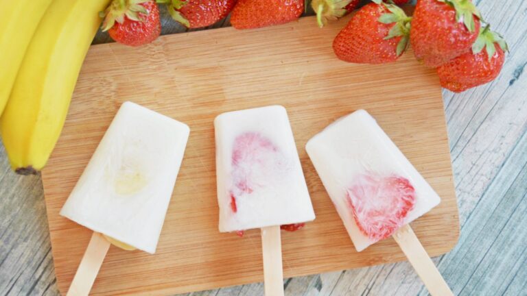 Homemade fruit popsicles on a cutting board