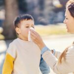 Mom wiping boy's nose