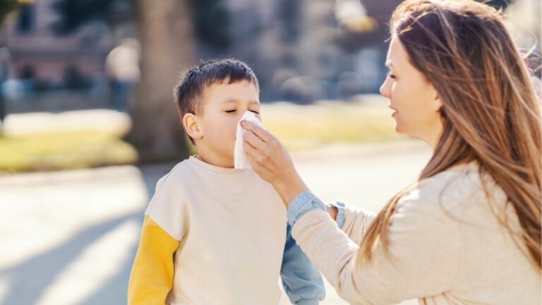 Mom wiping boy's nose