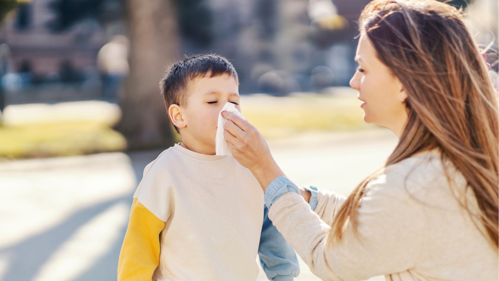 Mom wiping boy's nose