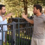 Neighbors arguing across their fence
