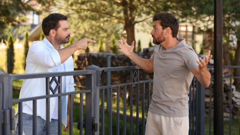 Neighbors arguing across their fence