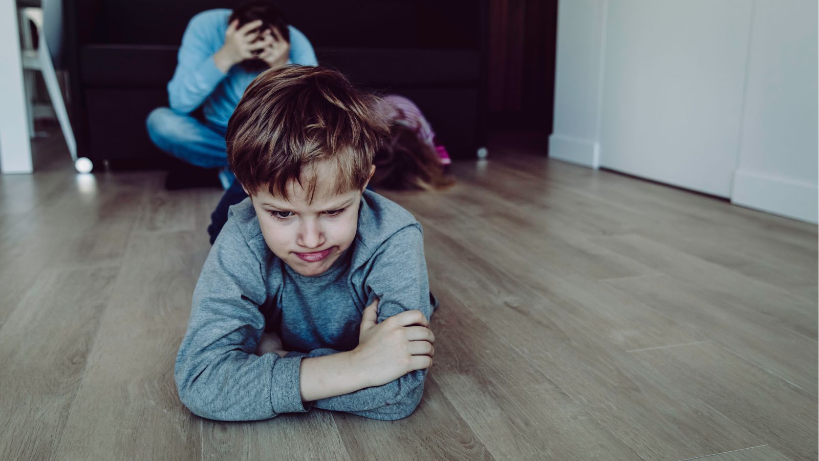Dad and little boy laying on the floor