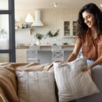 Woman arranging throw pillows on a couch