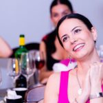 Women sitting at a bar with a bunch of glasses around