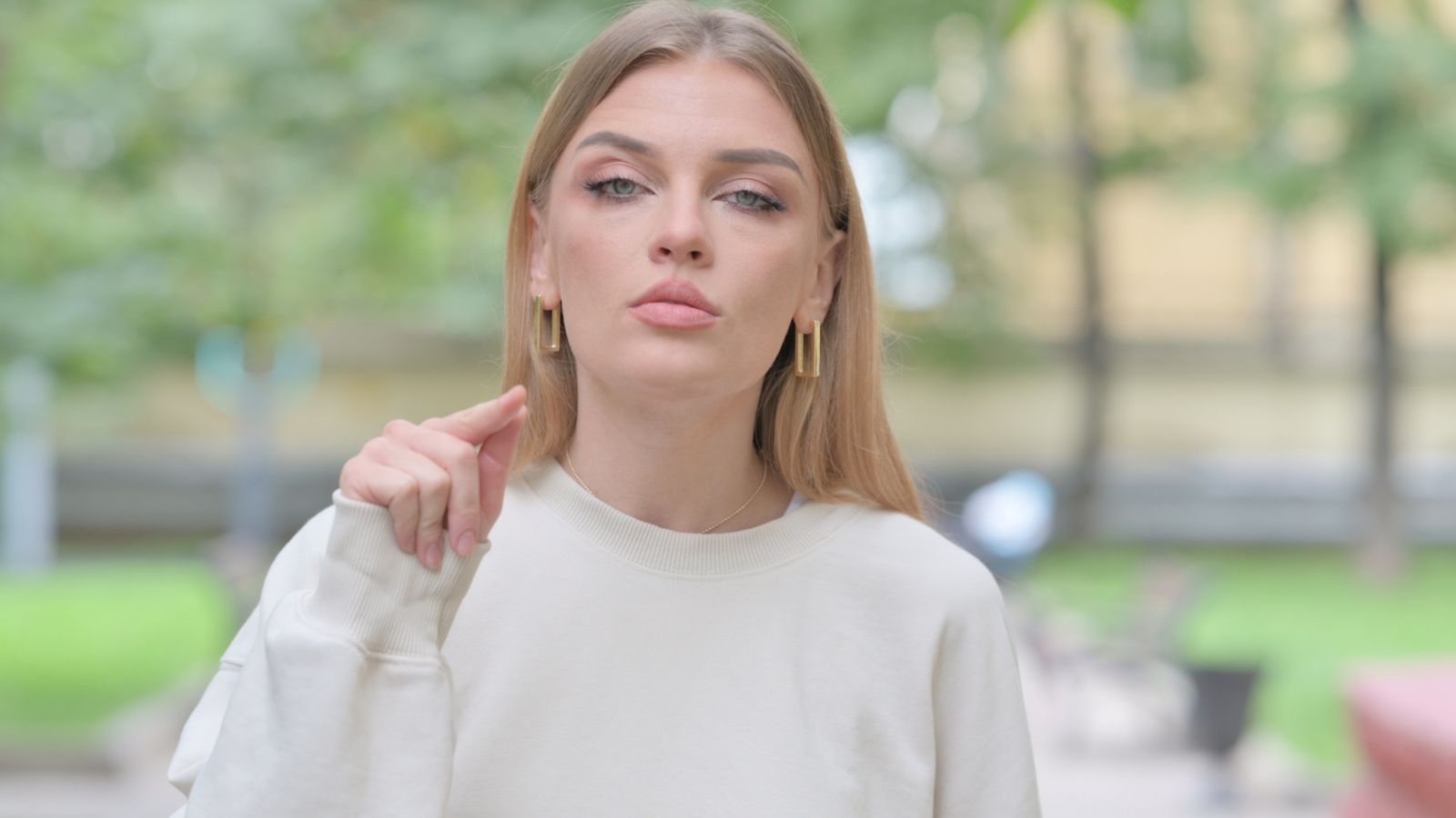 Woman standing outside looking mad