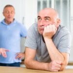Family looking annoyed with the man