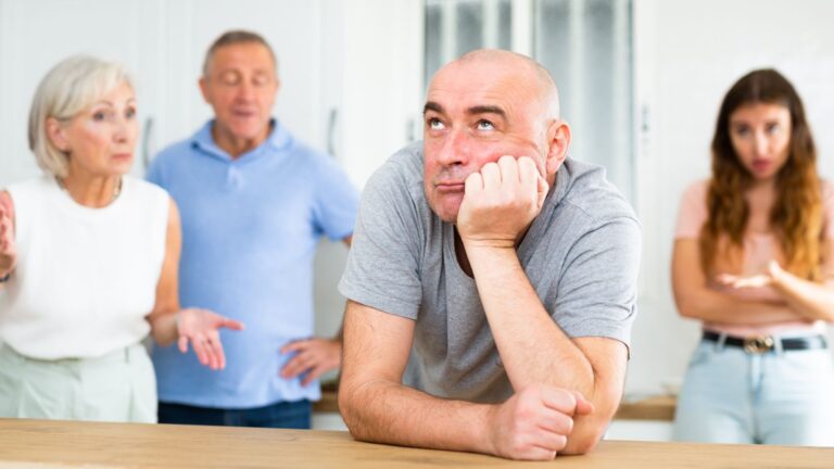 Family looking annoyed with the man