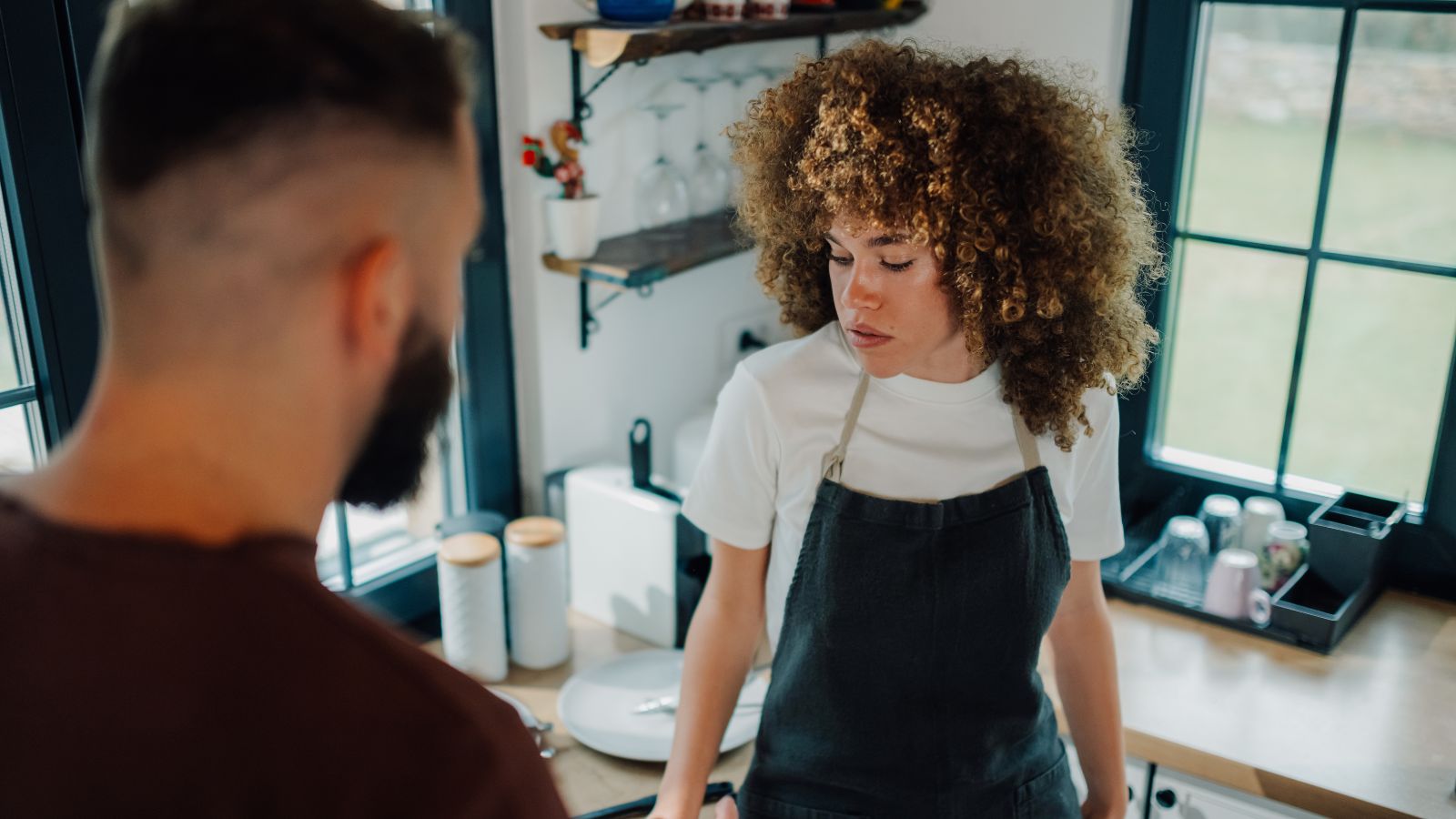 Female barista looking concerned with customer