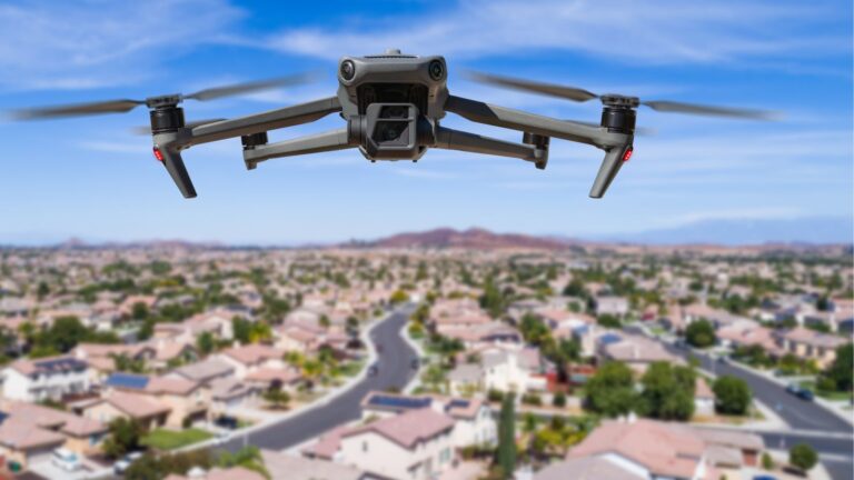 Black drone flying over a neighborhood