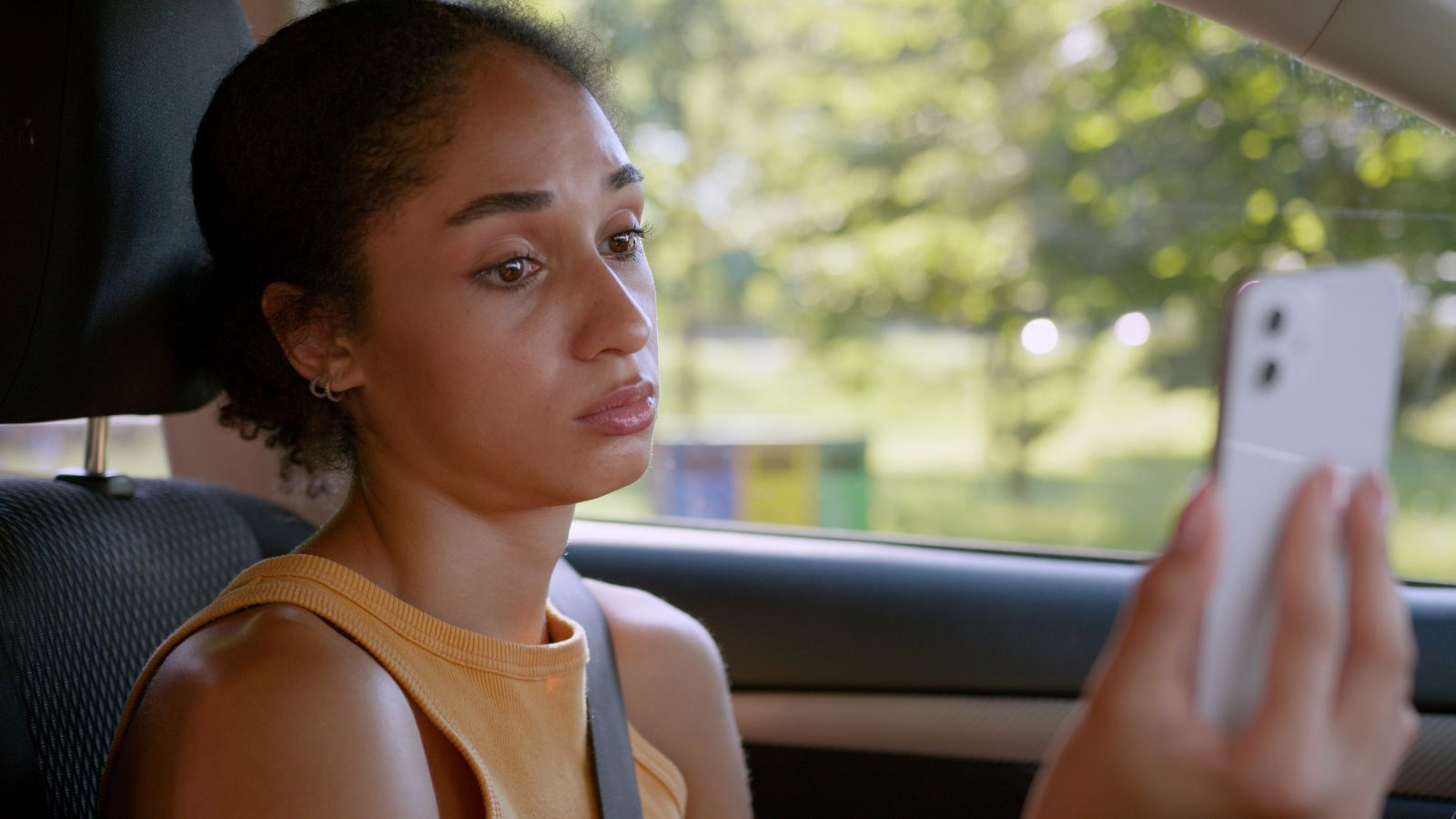 Young woman looking upset while on her phone