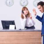 Businessman angry with hotel clerk